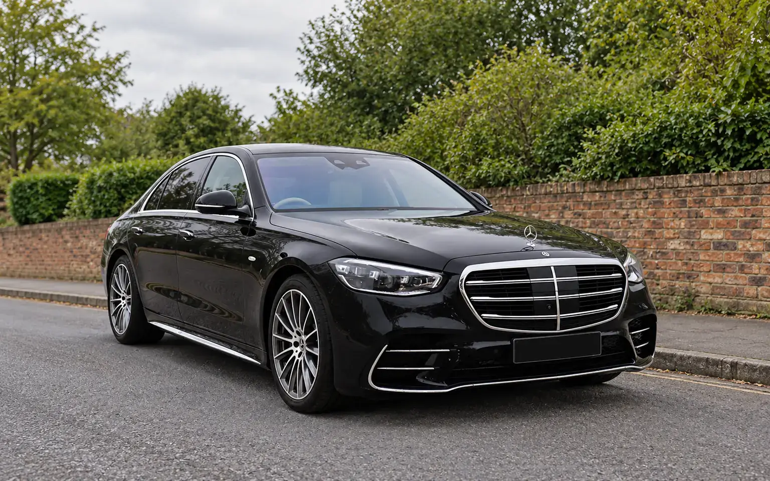 Black Mercedes S-Class on a quiet British roadside
